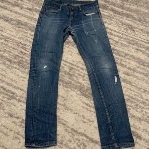 510 Men’s Levi jeans with paint splatter detail.